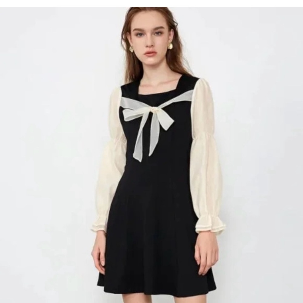 Elegant Black and Cream Dress with Bow